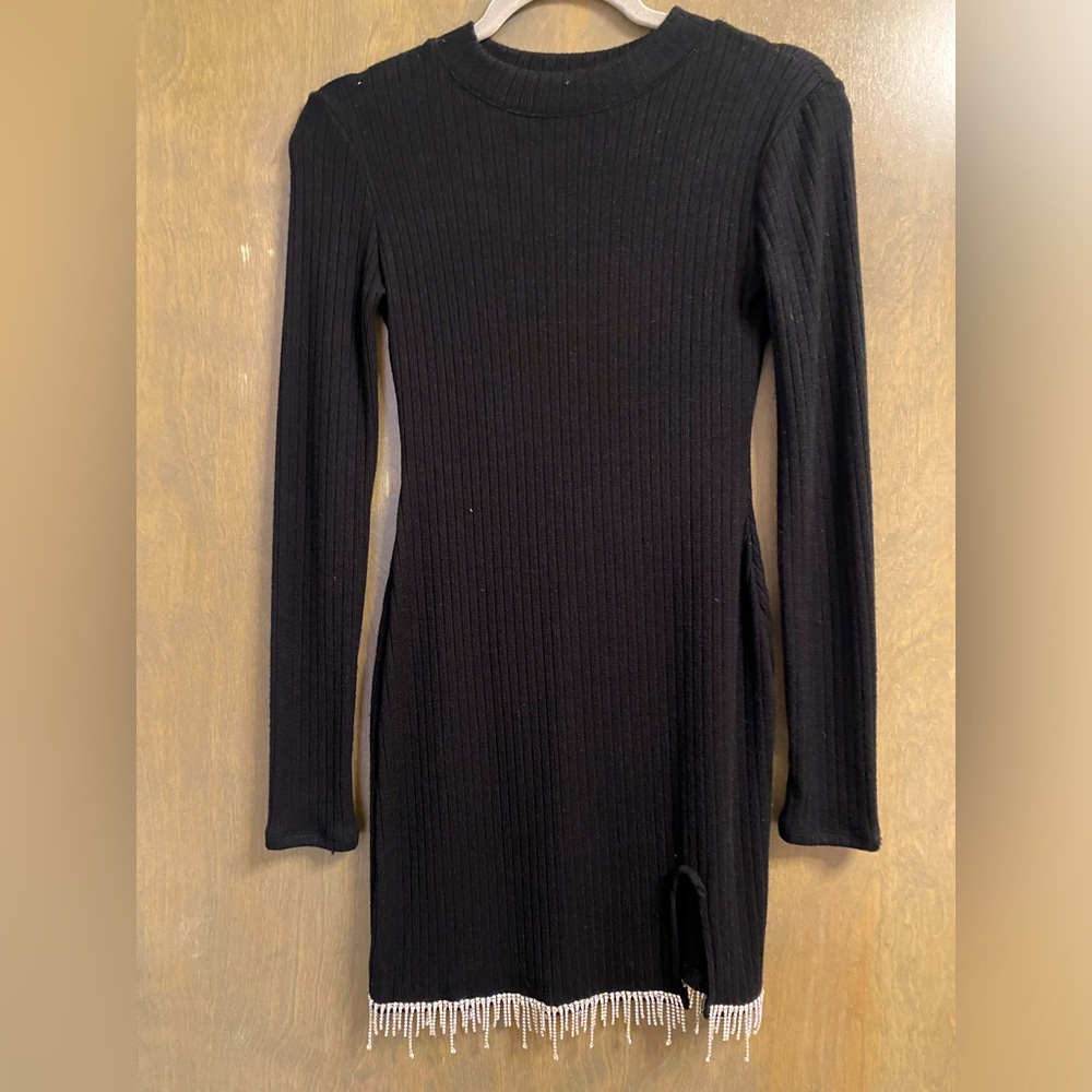 Stunning long sleeve ribbed black dress with small slit and dangling diamonds!
